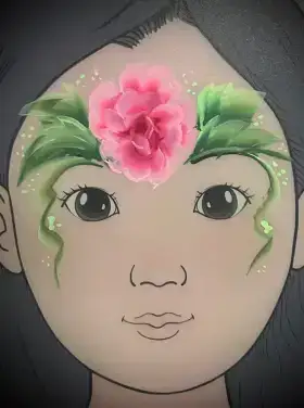 Pink rose flower face painting design with green leaves across the forehead.