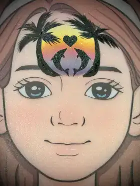 Dolphin and heart silhouette crown face painting design with warm sunset colors across the forehead.