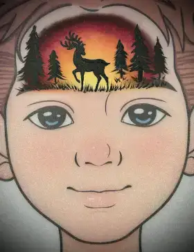 Deer silhouette crown face painting design with warm sunset colors across the forehead.