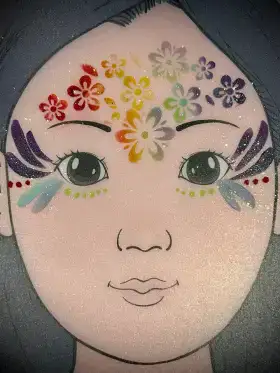 Spring flower crown face painting design with colorful blossoms.