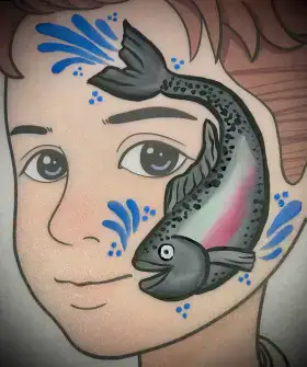 Colorful fish face painting design with shimmering scales and fins.